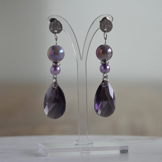 Zilverkleurige oorbellen met iriserende paarse kralen en facetgeslepen druppel